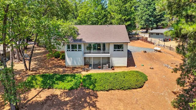 a view of a house with a yard and potted plants