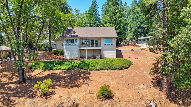 an aerial view of a house with a yard