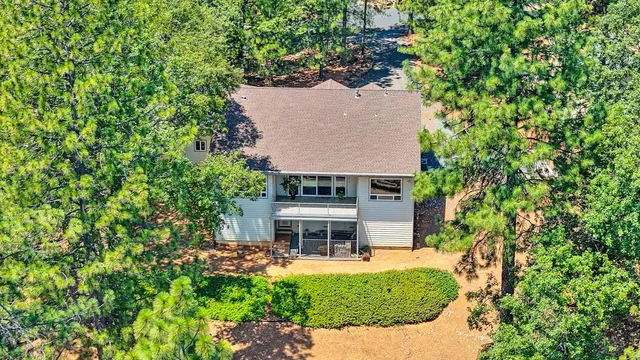 an aerial view of a house with a yard