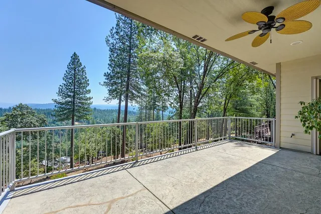 a view of a balcony with a tree