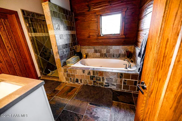 a bathroom with sink a mirror and shower