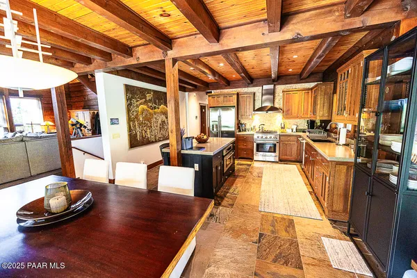 a view of a patio with couple of chairs and a fire pit