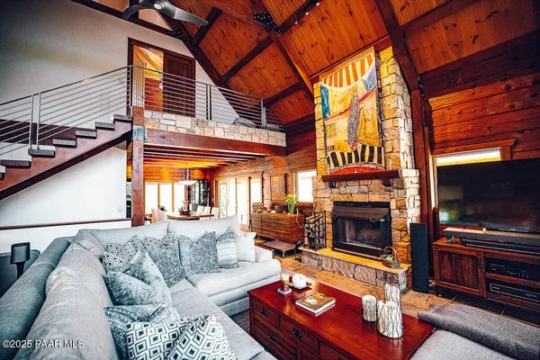 a bedroom with furniture and a flat screen tv