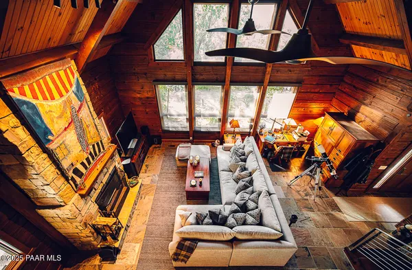 a view of a hallway with wooden floor and furniture