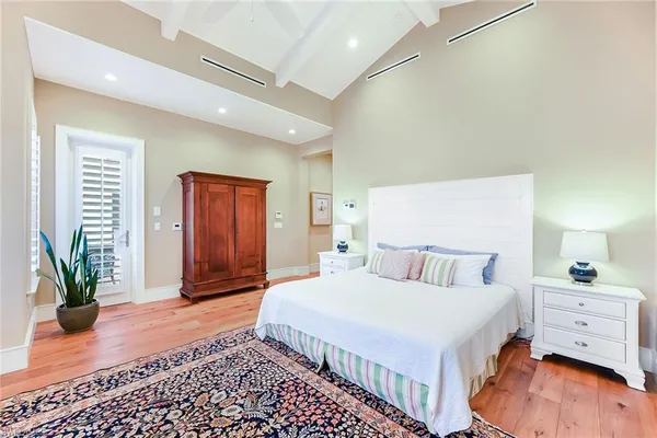 a bedroom with a bed and a potted plant