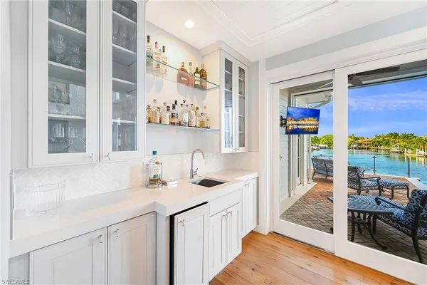 a bathroom with a sink a mirror and next to a window