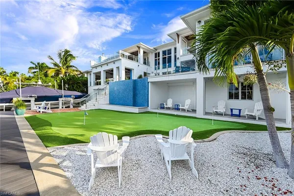 swimming pool view with a seating space