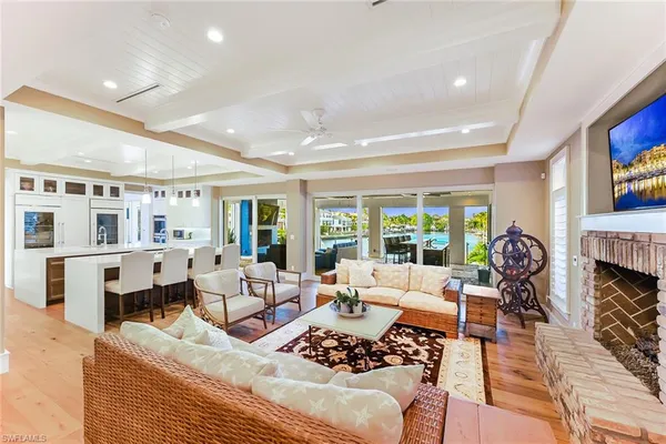 a living room with furniture large window and a fireplace