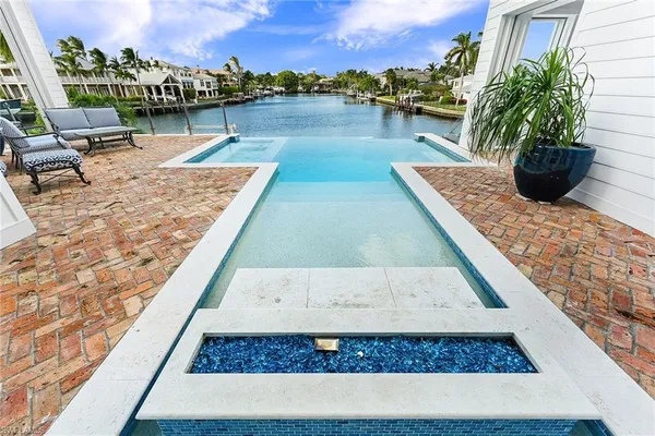 a view of a swimming pool with an outdoor seating