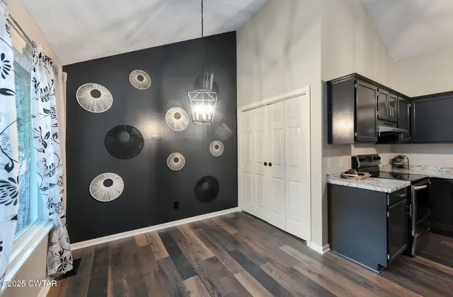 a kitchen with stainless steel appliances granite countertop a refrigerator and a stove