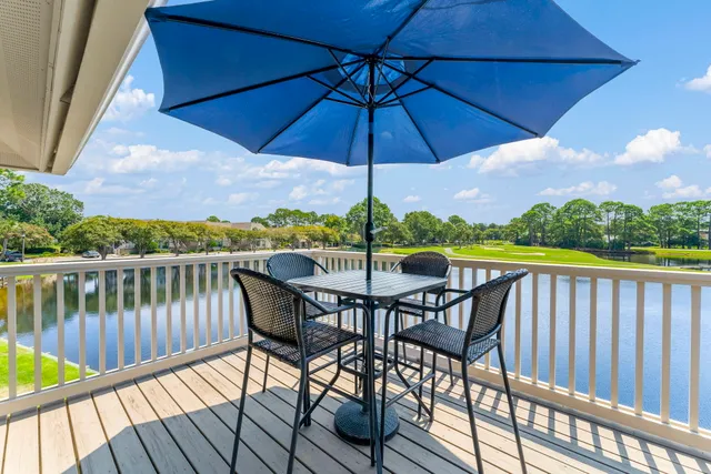 a view of a balcony with wooden floor and outdoor space