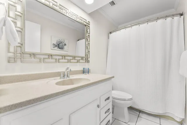 a bathroom with a granite countertop sink mirror vanity and toilet