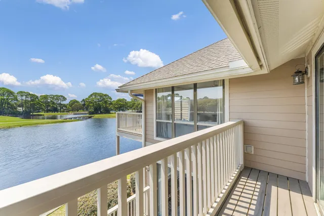 a view of a balcony with lake view and wooden floor
