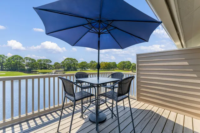 a view of balcony with furniture and umbrella