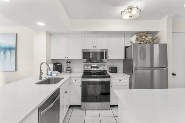 a kitchen with a sink a stove and refrigerator