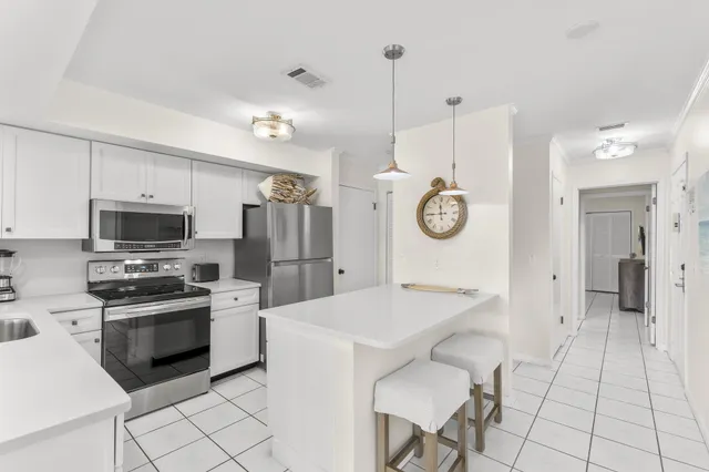 a kitchen with stainless steel appliances a stove a sink and a refrigerator