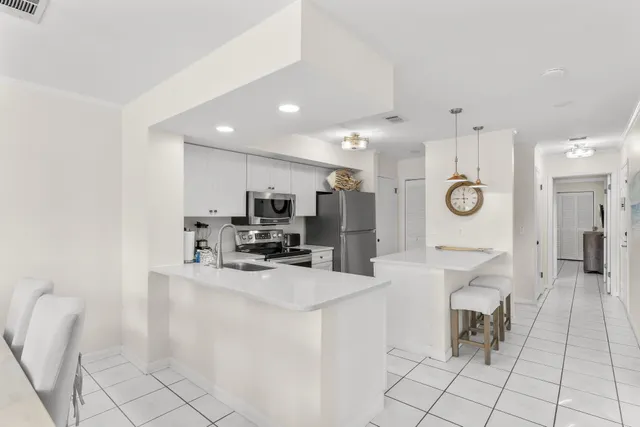 a kitchen with stainless steel appliances kitchen island granite countertop a sink and cabinets