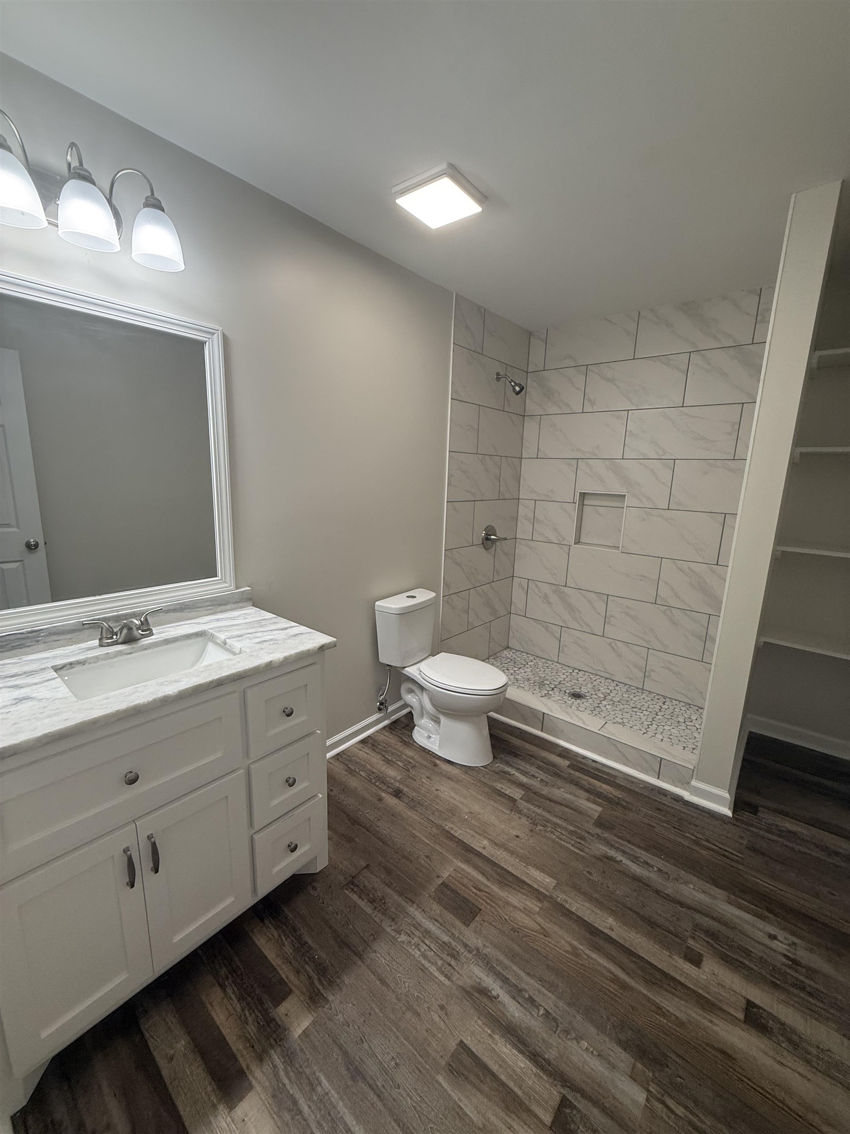 195 Poole Road Moscow, TN 38057 - Photo 15 of 21 Bathroom featuring a white vanity with a stone-finish countertop, undermount sink, and chrome faucet