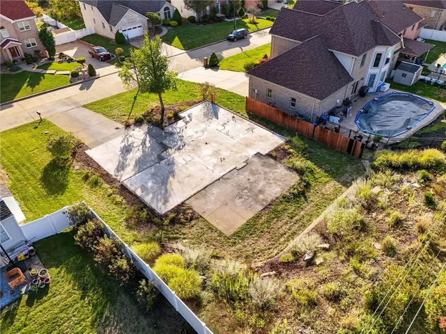 an aerial view of a house with a garden and swimming pool
