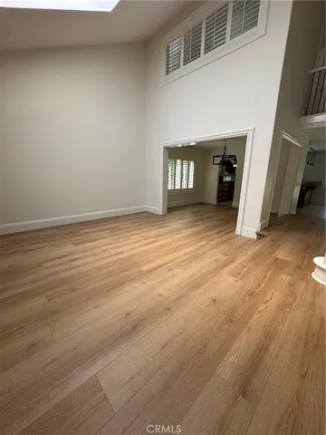 a view of a livingroom with an empty space and a window