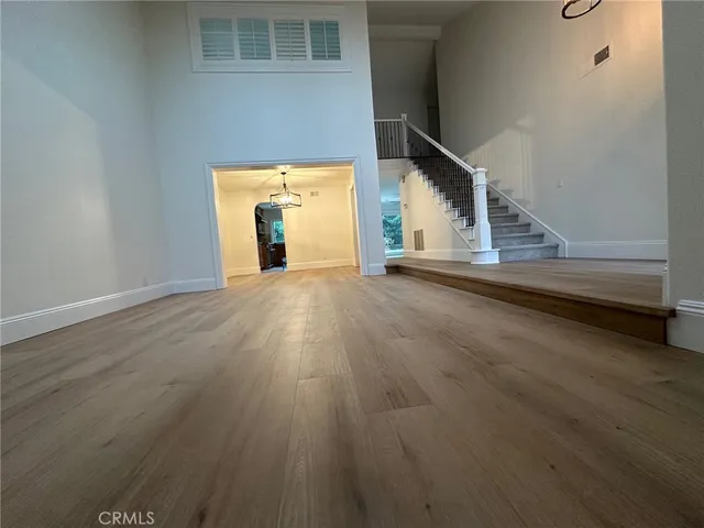 a view of a room with wooden floor and a window