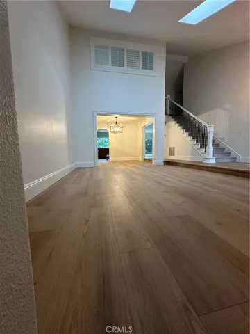 a view of a livingroom with wooden floor and a window