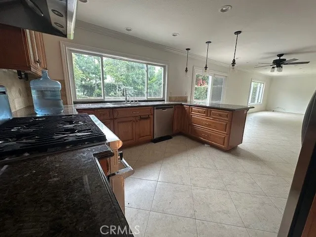 a kitchen with stainless steel appliances granite countertop a stove a sink and a refrigerator