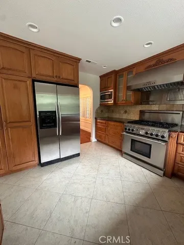 a kitchen with stainless steel appliances granite countertop a stove and a refrigerator