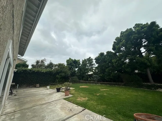 an empty room with a fireplace and windows