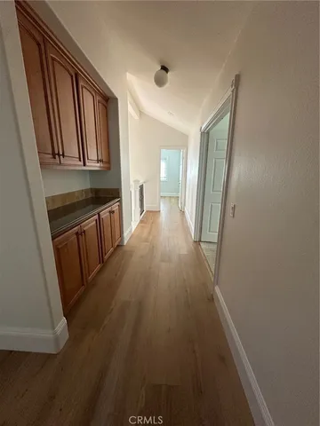 a large kitchen with stainless steel appliances a large counter top