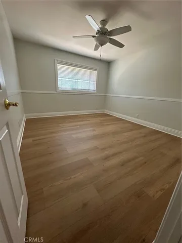 a view of a room with wooden floor and windows
