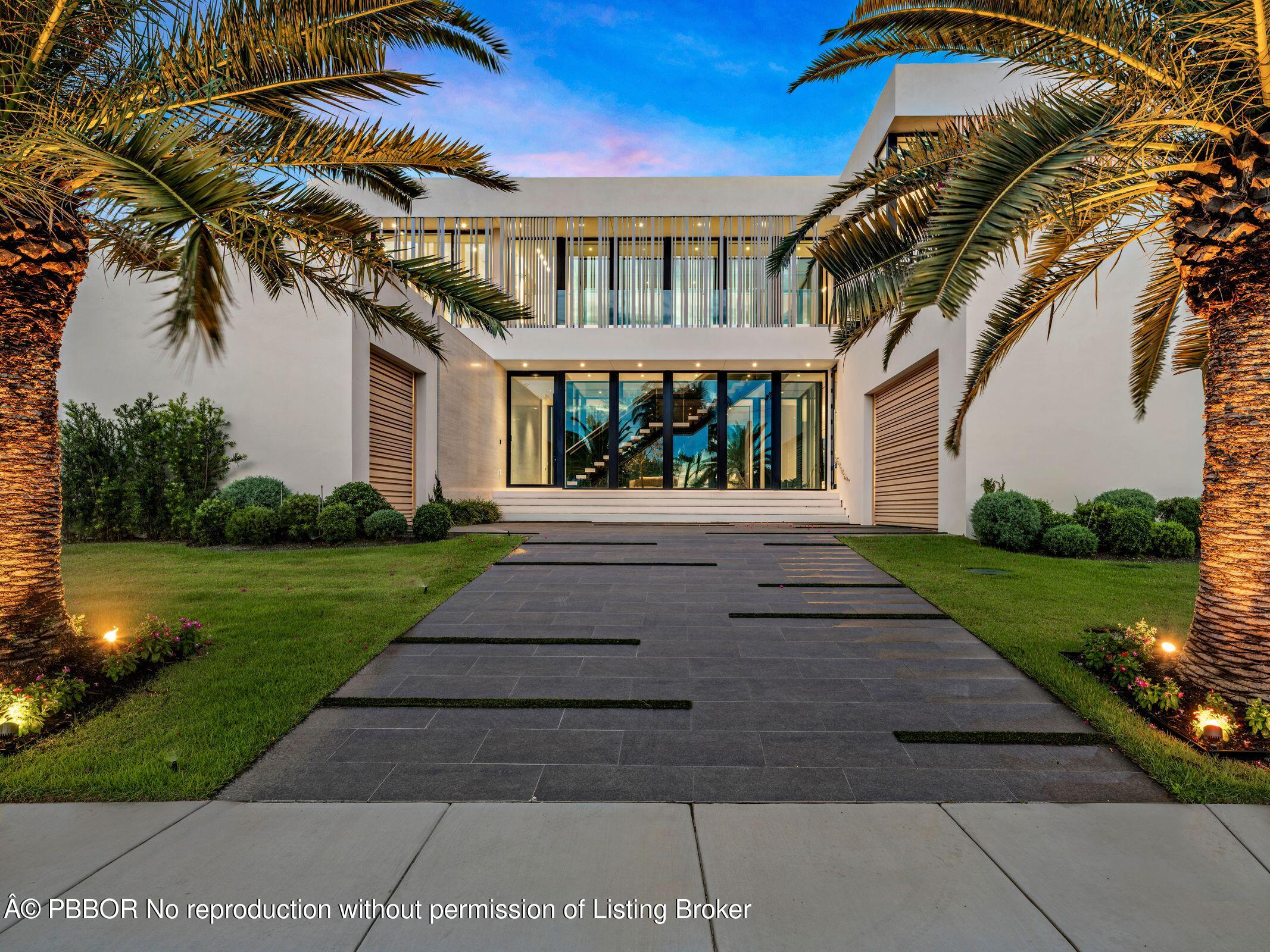35 Spoonbill Road Manalapan, FL 33462 - Photo 2 of 27 a front view of a house with a garden and trees