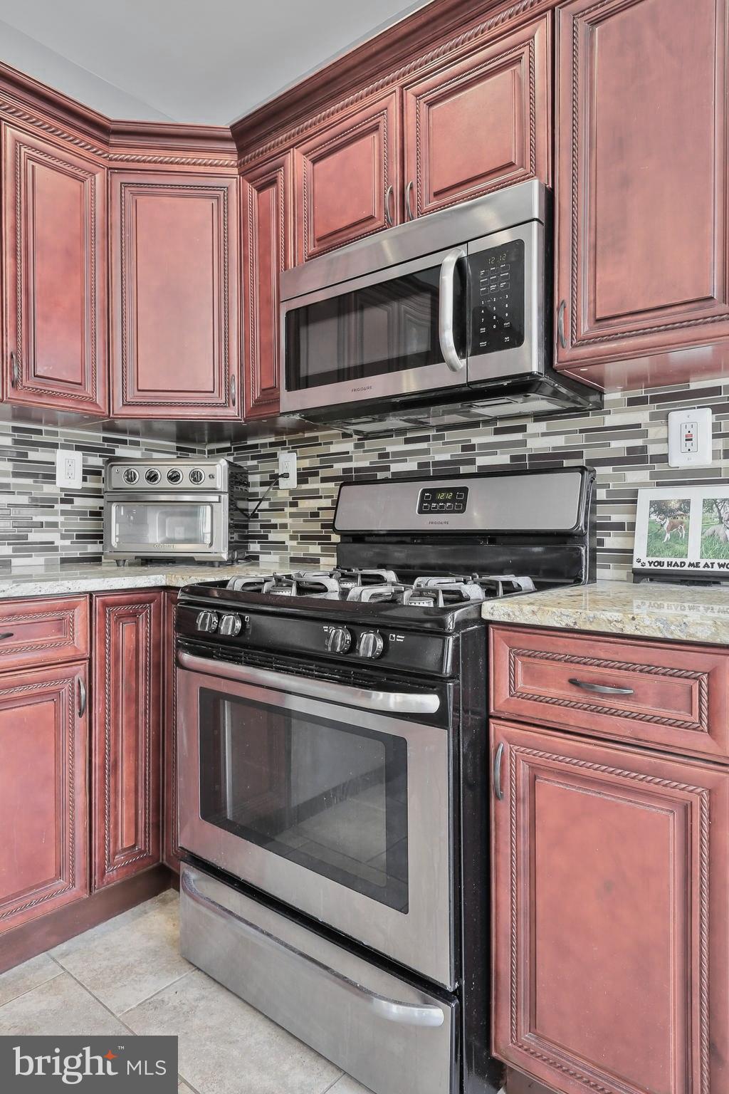 5609 Tramore Road Baltimore, MD 21214 - Photo 13 of 42 Gas stove and built in microwave.
