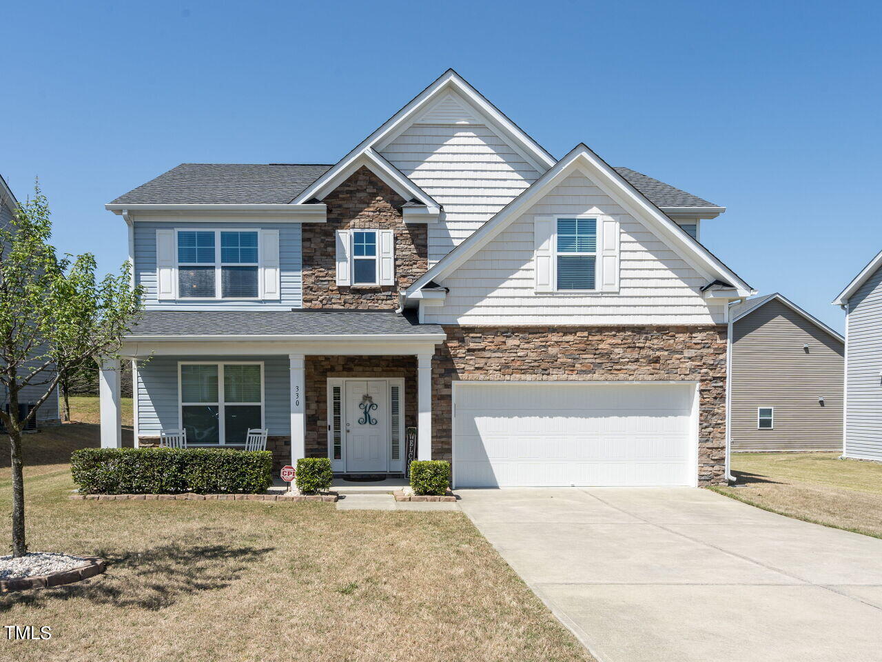 330 Hope Valley Road Knightdale, NC 27545 - Photo 1 of 41 a front view of a house with a yard and garage
