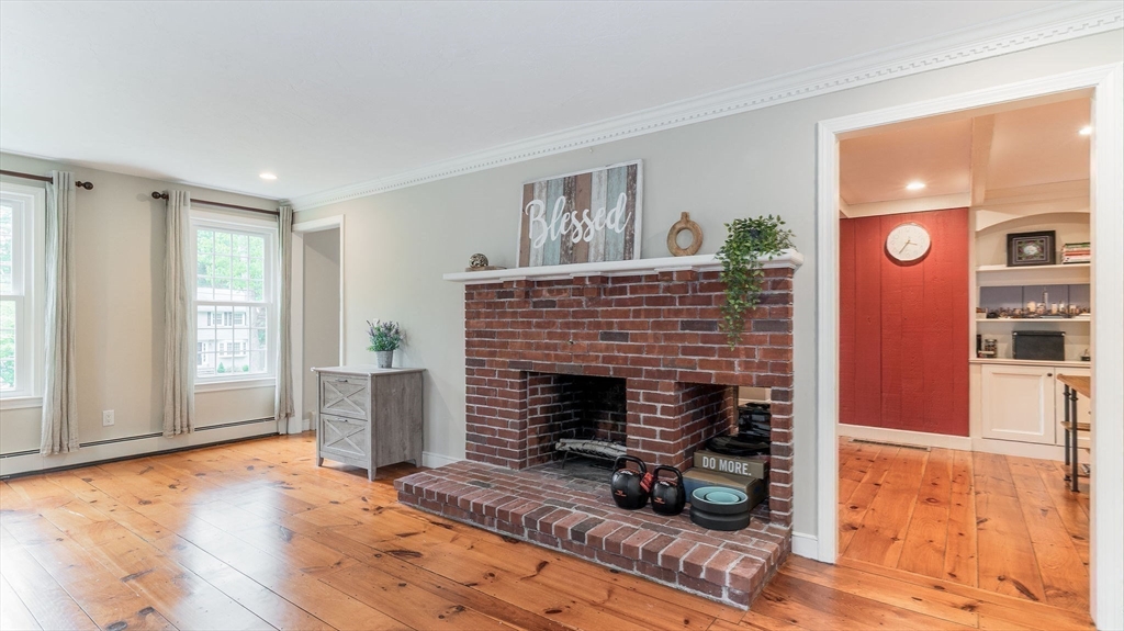 142 Baker Street Walpole, MA 02081 - Photo 20 of 42 a living room with furniture and a fireplace