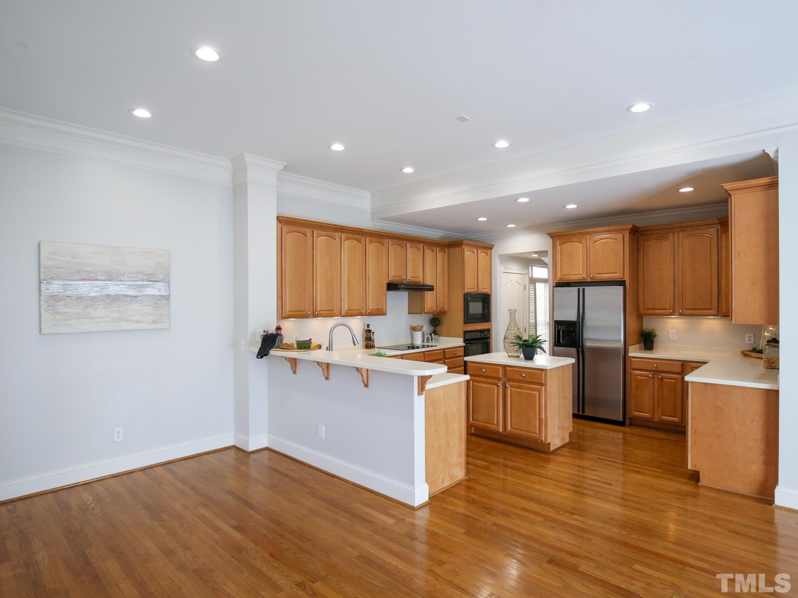 3905 Bentley Meadow Lane Raleigh, NC 27612 - Photo 13 of 40 a kitchen with a sink cabinets and wooden floor