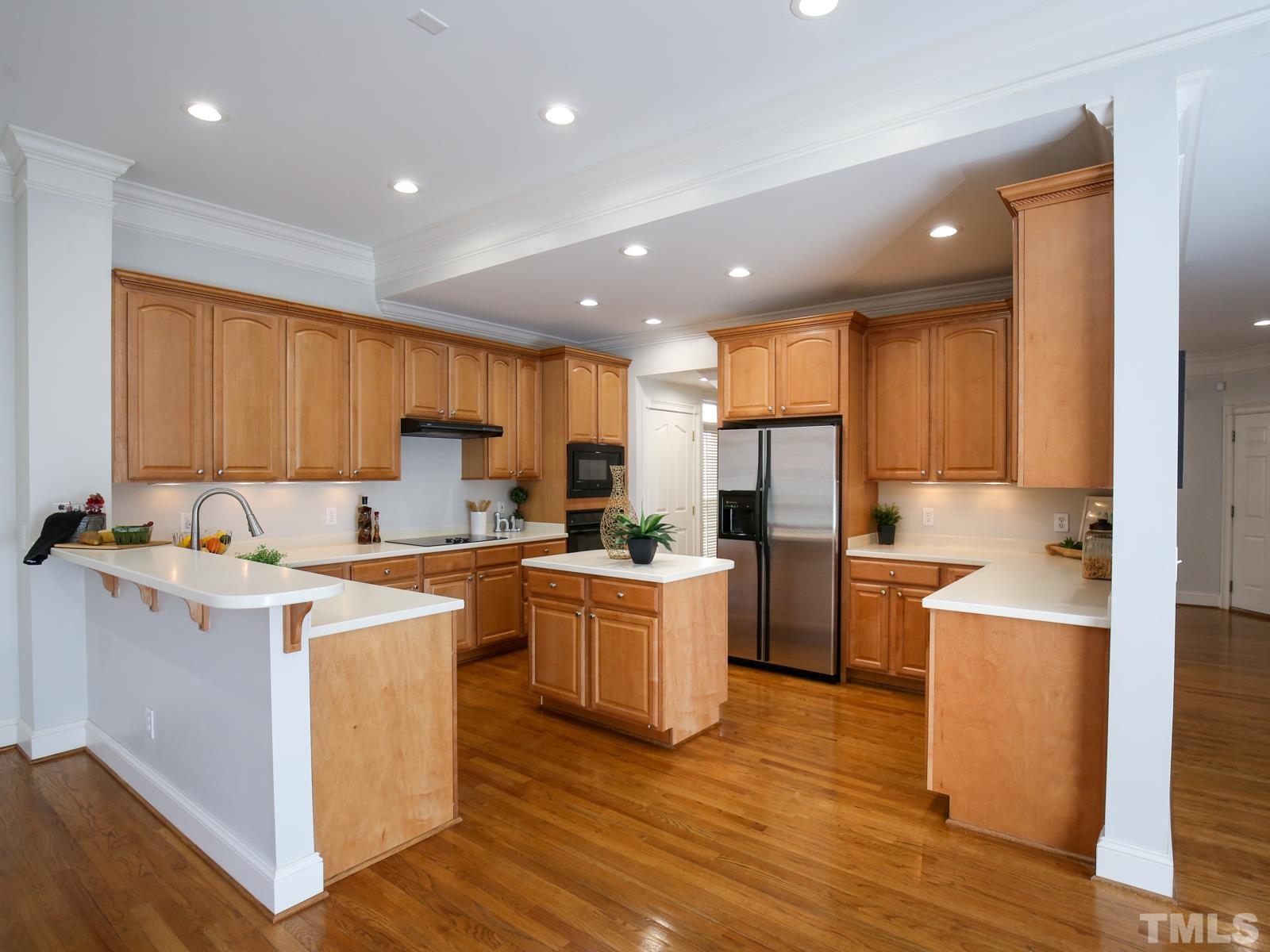 3905 Bentley Meadow Lane Raleigh, NC 27612 - Photo 14 of 40 a kitchen with a sink a counter top space stainless steel appliances and cabinets