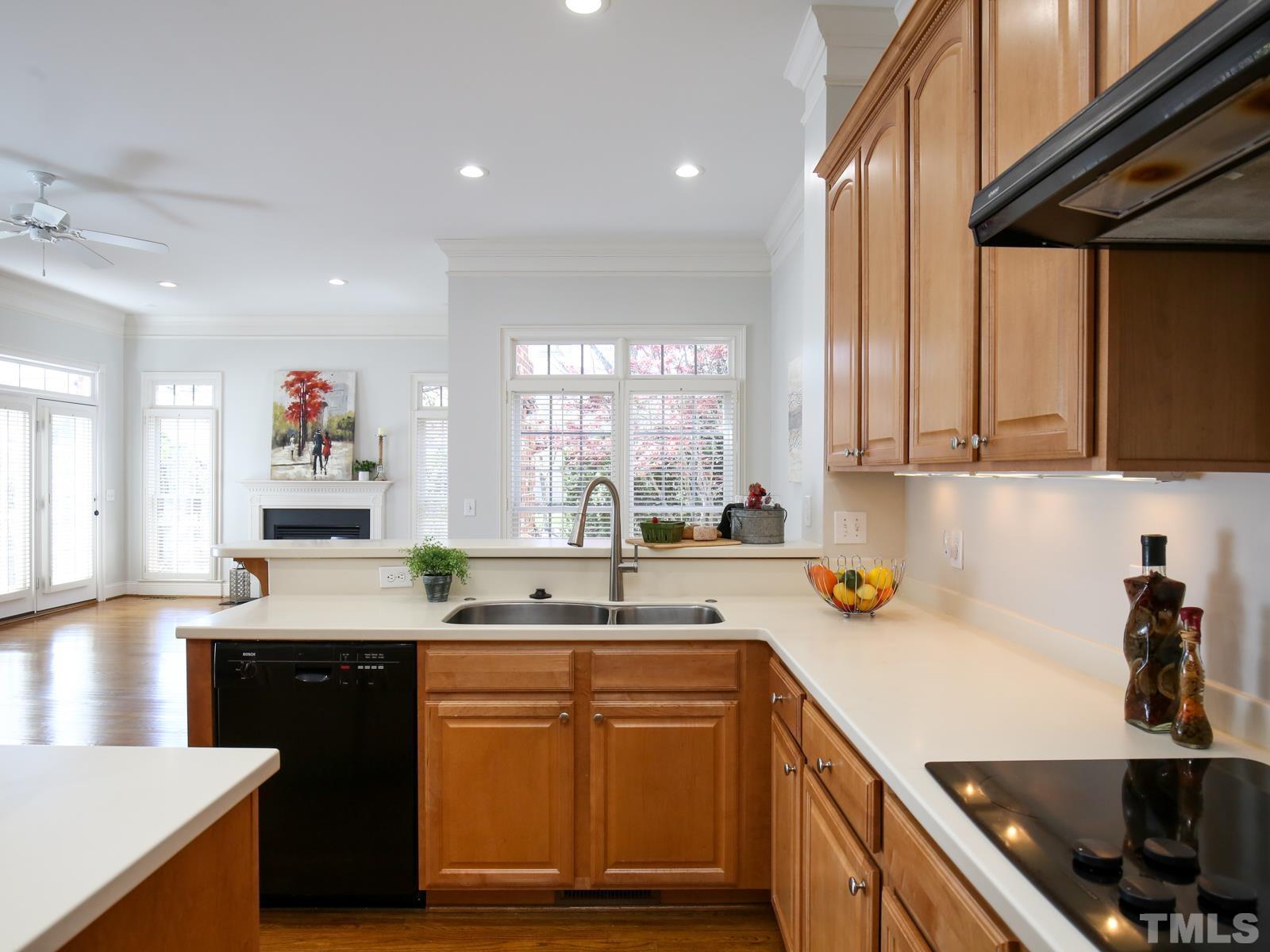 3905 Bentley Meadow Lane Raleigh, NC 27612 - Photo 17 of 40 a kitchen with stainless steel appliances granite countertop a sink a stove and cabinets