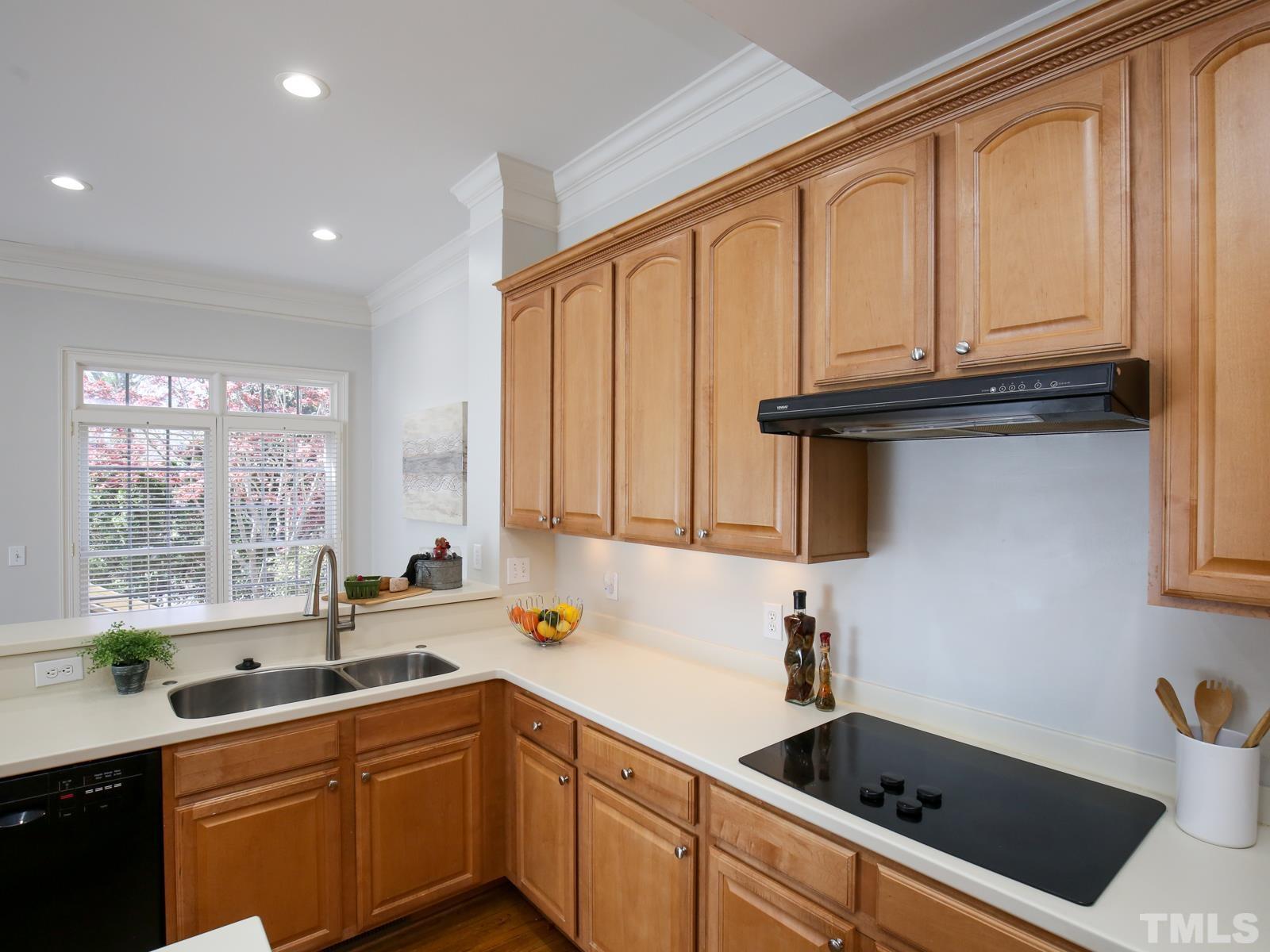 3905 Bentley Meadow Lane Raleigh, NC 27612 - Photo 18 of 40 a kitchen with stainless steel appliances granite countertop a sink a stove and cabinets