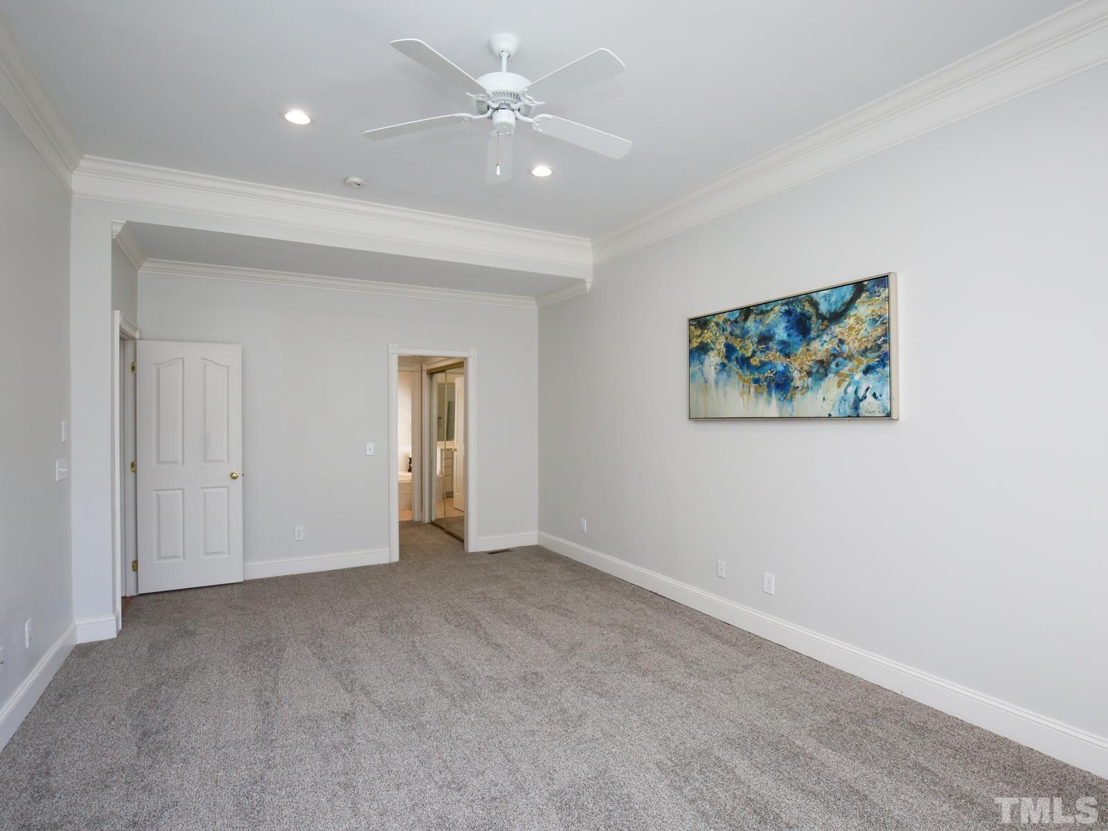 3905 Bentley Meadow Lane Raleigh, NC 27612 - Photo 23 of 40 an empty room with a ceiling fan and a window