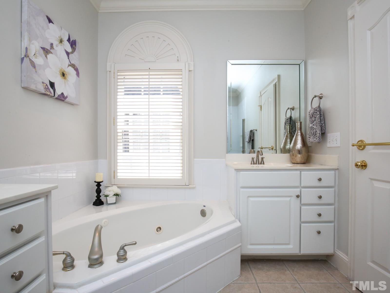 3905 Bentley Meadow Lane Raleigh, NC 27612 - Photo 24 of 40 a bathroom with a tub sink and mirror