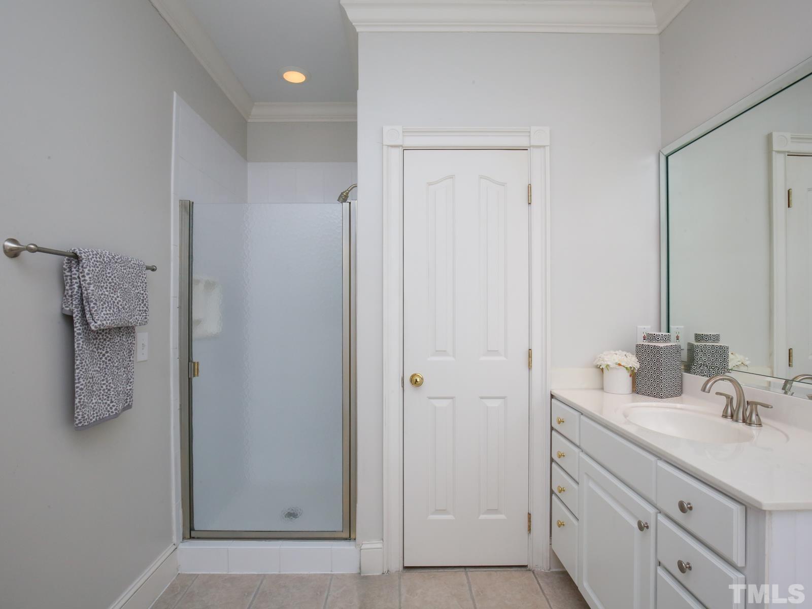 3905 Bentley Meadow Lane Raleigh, NC 27612 - Photo 25 of 40 a bathroom with a double vanity sink a mirror and a shower