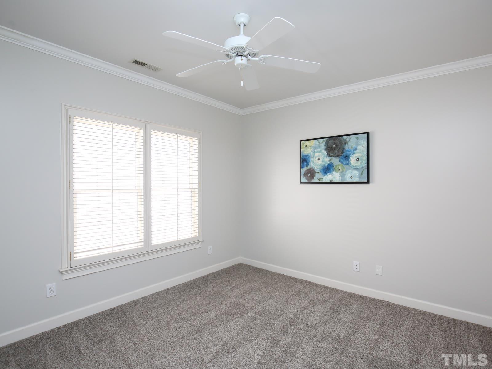 3905 Bentley Meadow Lane Raleigh, NC 27612 - Photo 27 of 40 an empty room with windows and ceiling fan