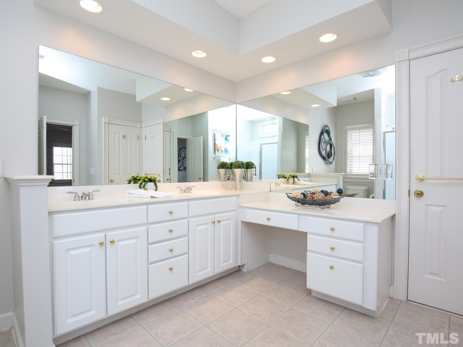 3905 Bentley Meadow Lane Raleigh, NC 27612 - Photo 31 of 40 a spacious bathroom with a double vanity sink and a mirror