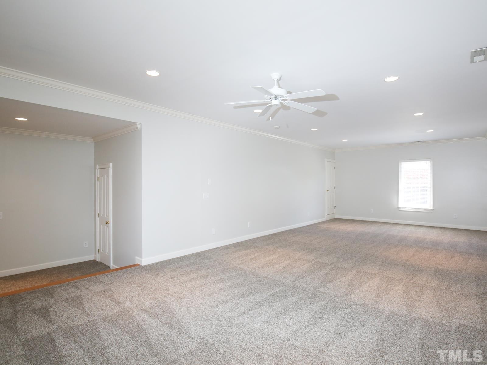 3905 Bentley Meadow Lane Raleigh, NC 27612 - Photo 34 of 40 a view of an empty room with a ceiling fan