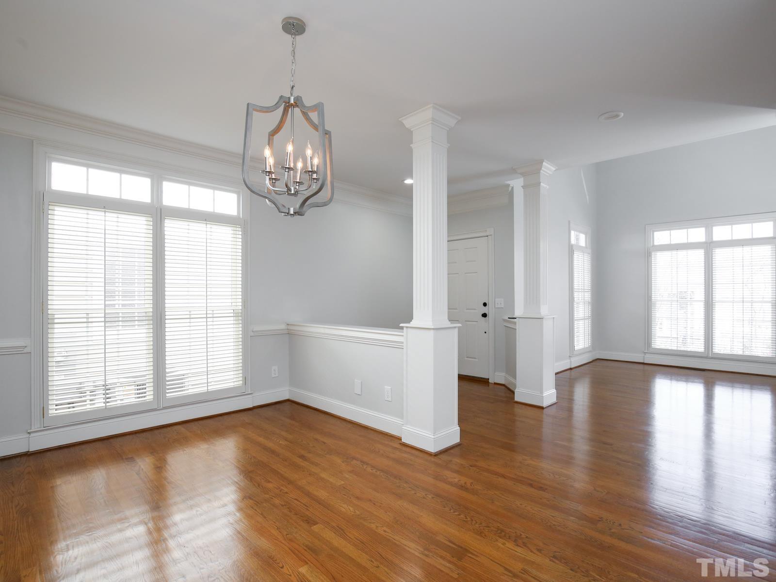 3905 Bentley Meadow Lane Raleigh, NC 27612 - Photo 5 of 40 a view of an empty room with wooden floor and a window