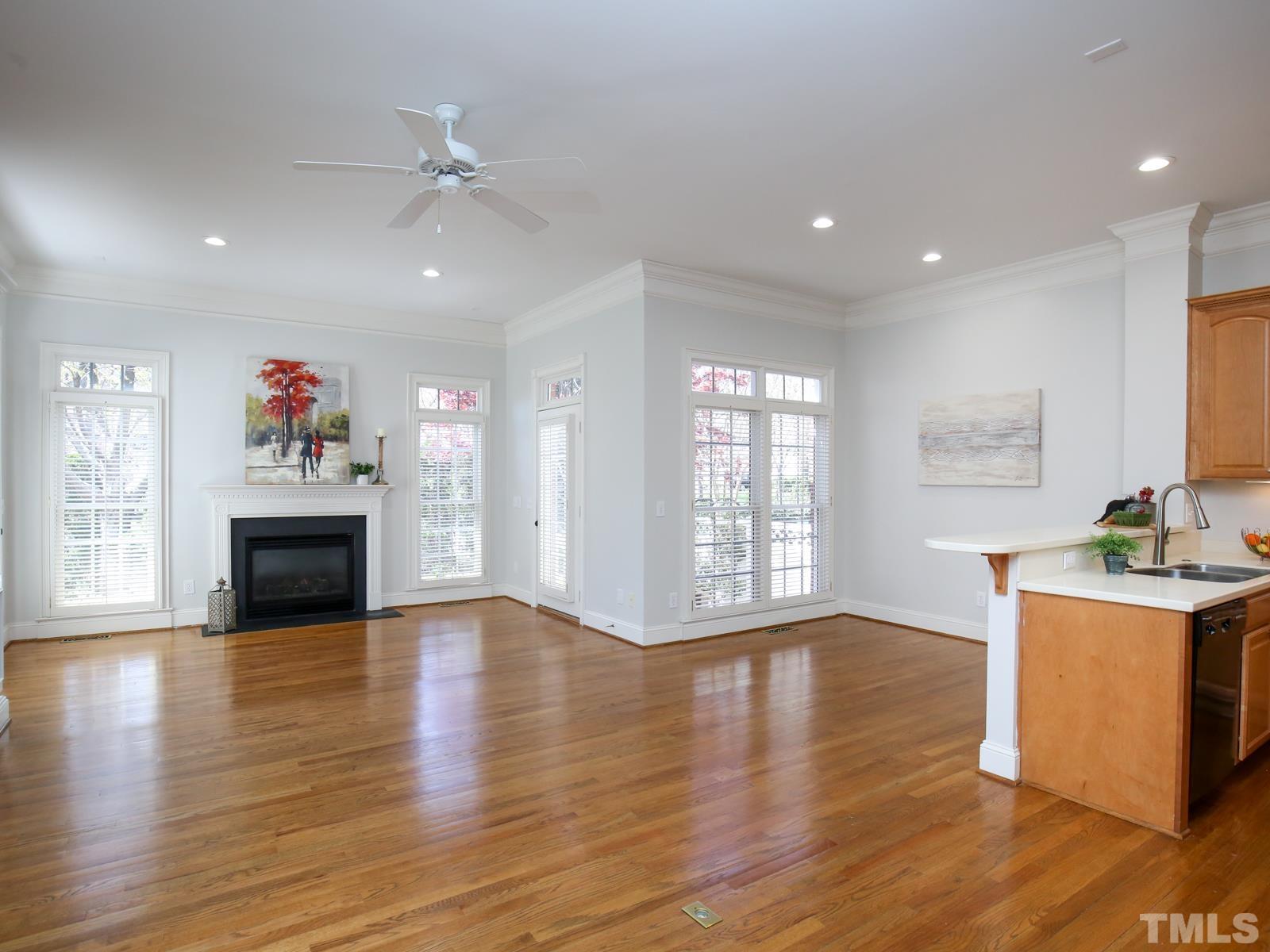 3905 Bentley Meadow Lane Raleigh, NC 27612 - Photo 8 of 40 a view of a kitchen with a stove wooden floor and a fireplace