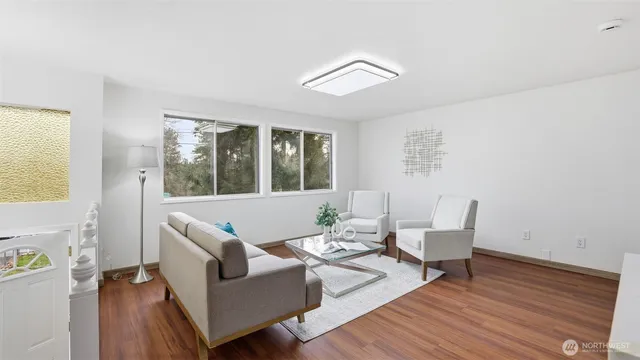 a living room with furniture and wooden floor