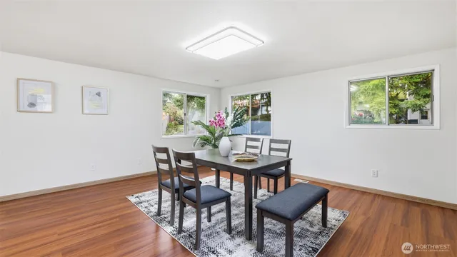 a view of a dining room with furniture and wooden floor