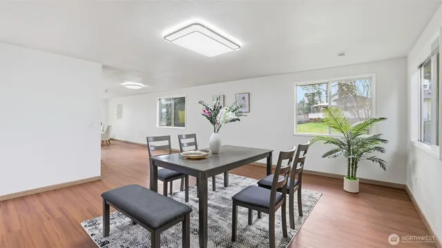 a view of a dining room with furniture window and wooden floor